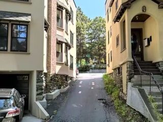 Driveway entrance between the buildings at 195 Rawson Road